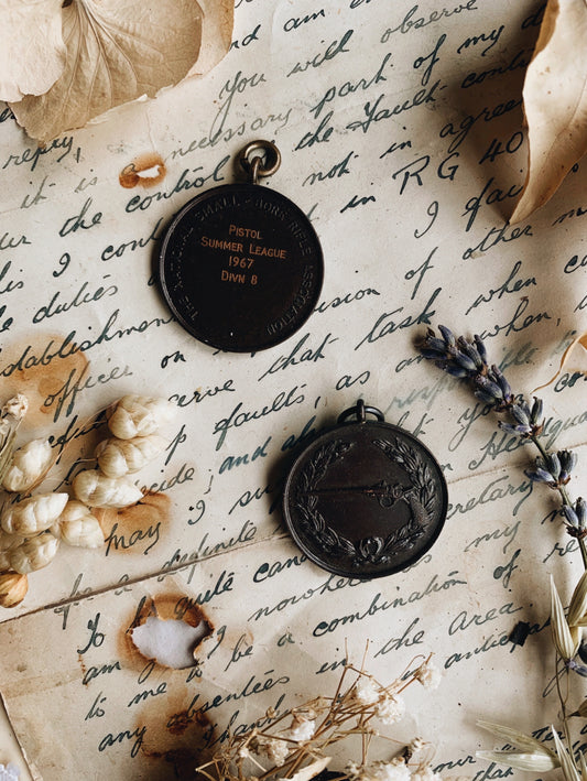 Two Vintage 1960’s Pistol Medallions