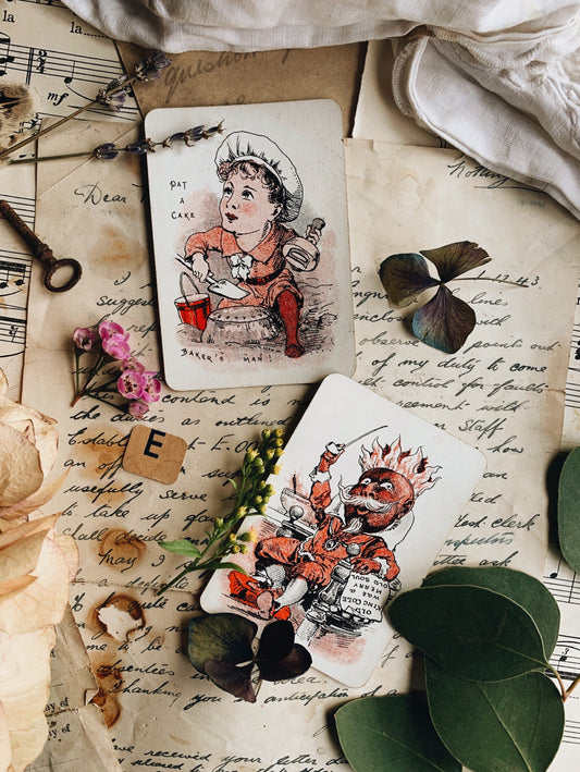 A Pair of Antique 1920’s Snap Cards ~ Pat a cake & king Cole